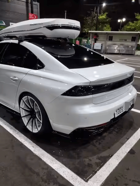 black and white rims on white car